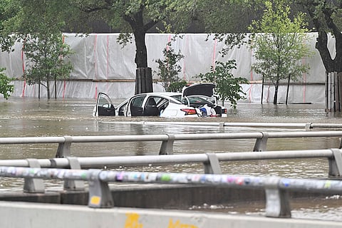 A vehicle is stranded on  flooded Allen Parkway